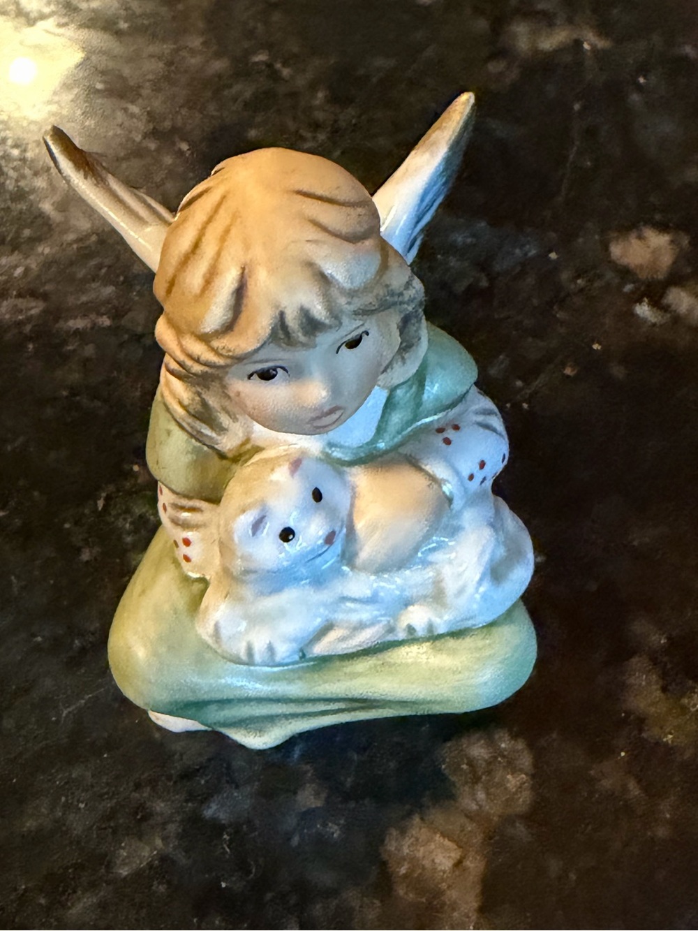 Vintage miniature ceramic Gobel angel holding a cat figurine